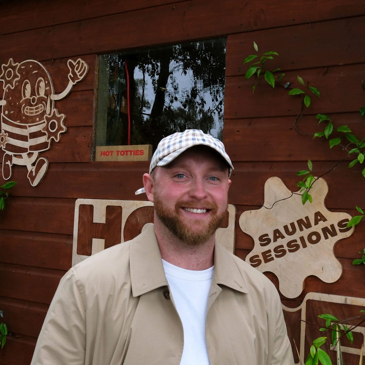 Kieran, smiling in front of the Hot Tottie sauna hut